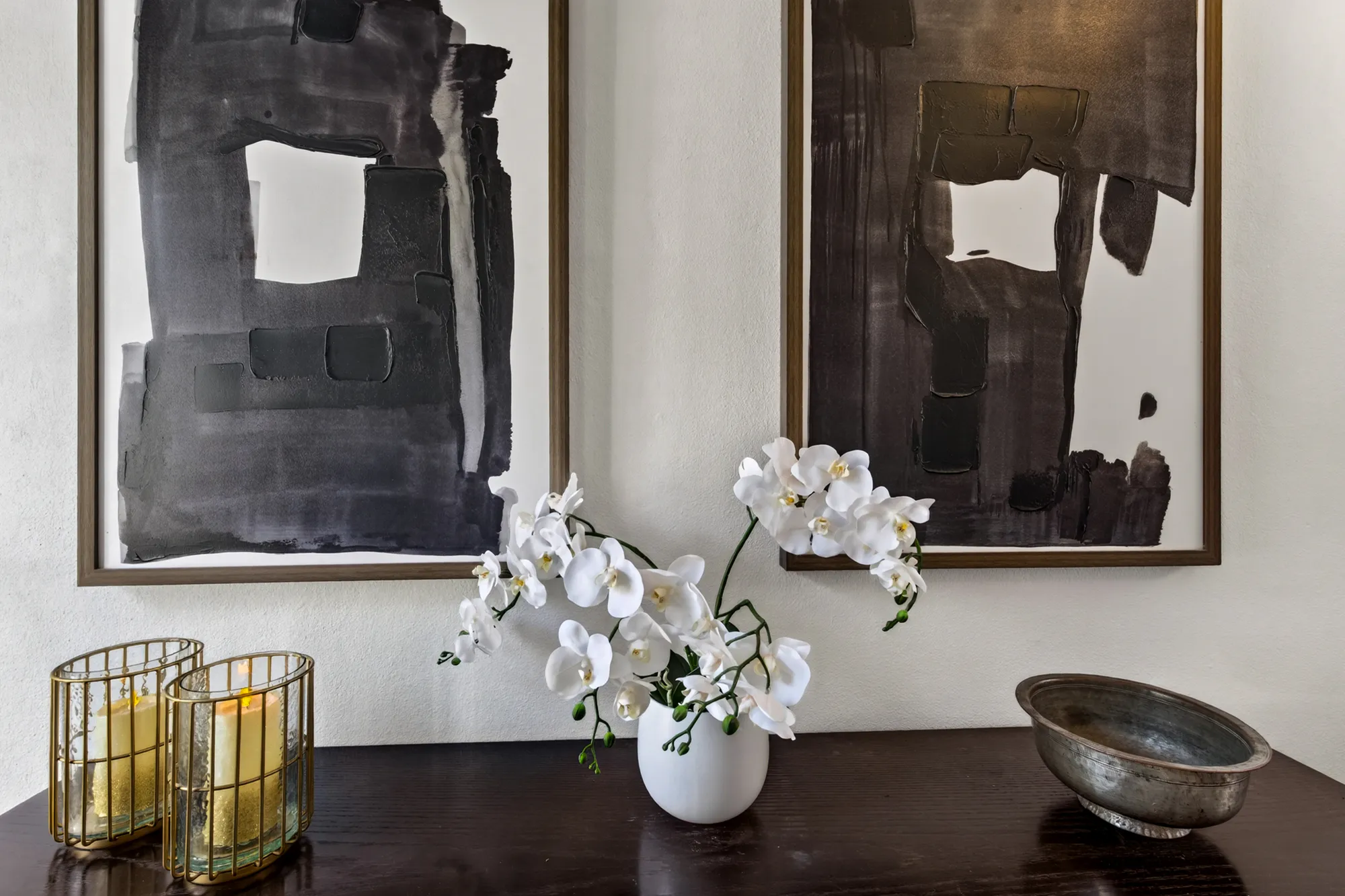 White orchids and candles on the entrance console at Casa Dias